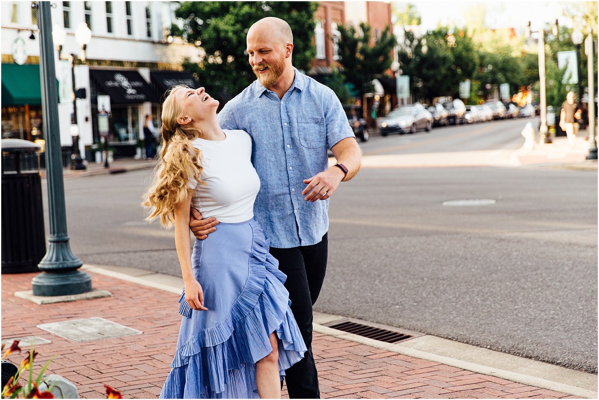 Couple laughing together while walking down sidewalk in downtown Franklin