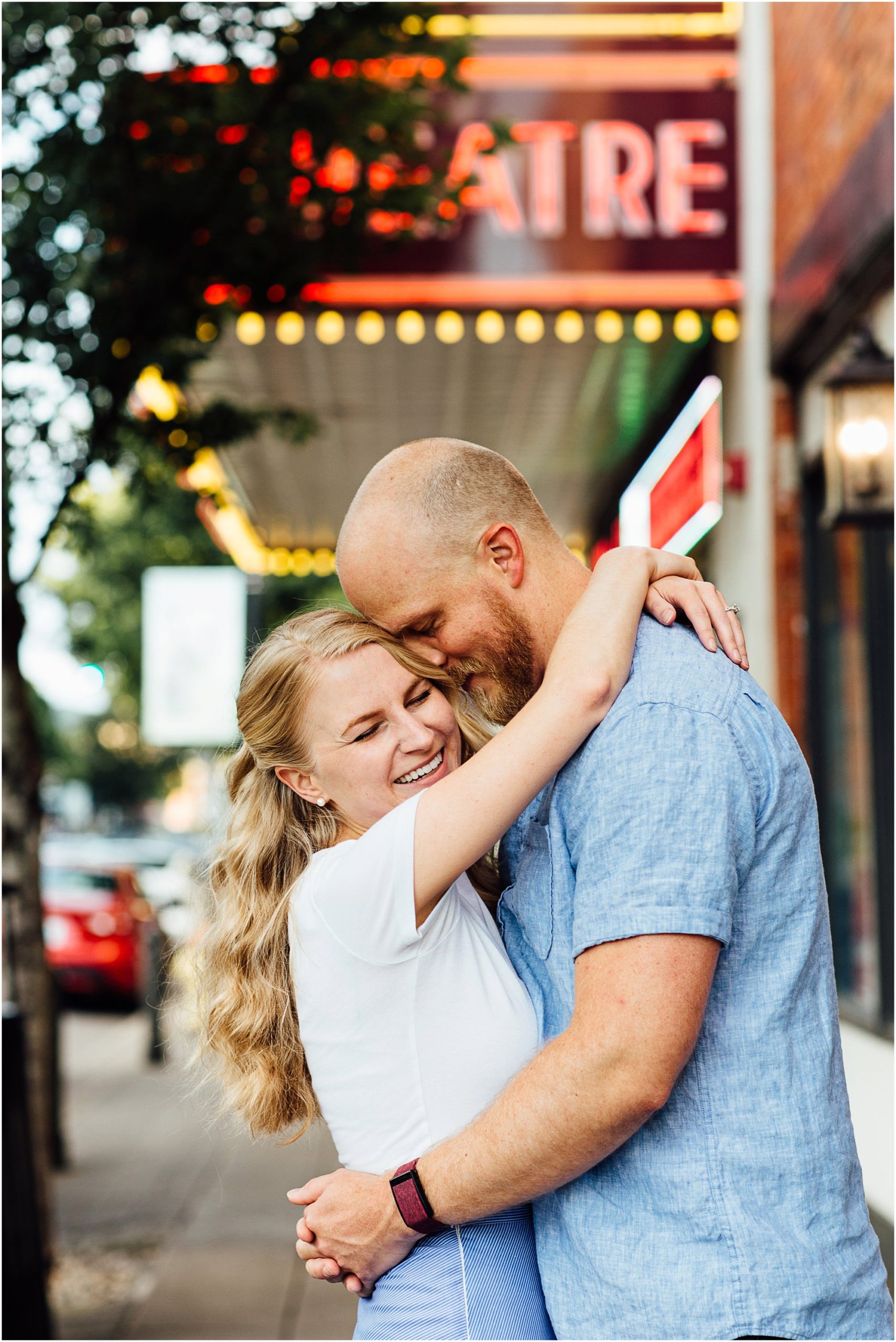 Couple hugging with big smiles in front of Franklin Theatre