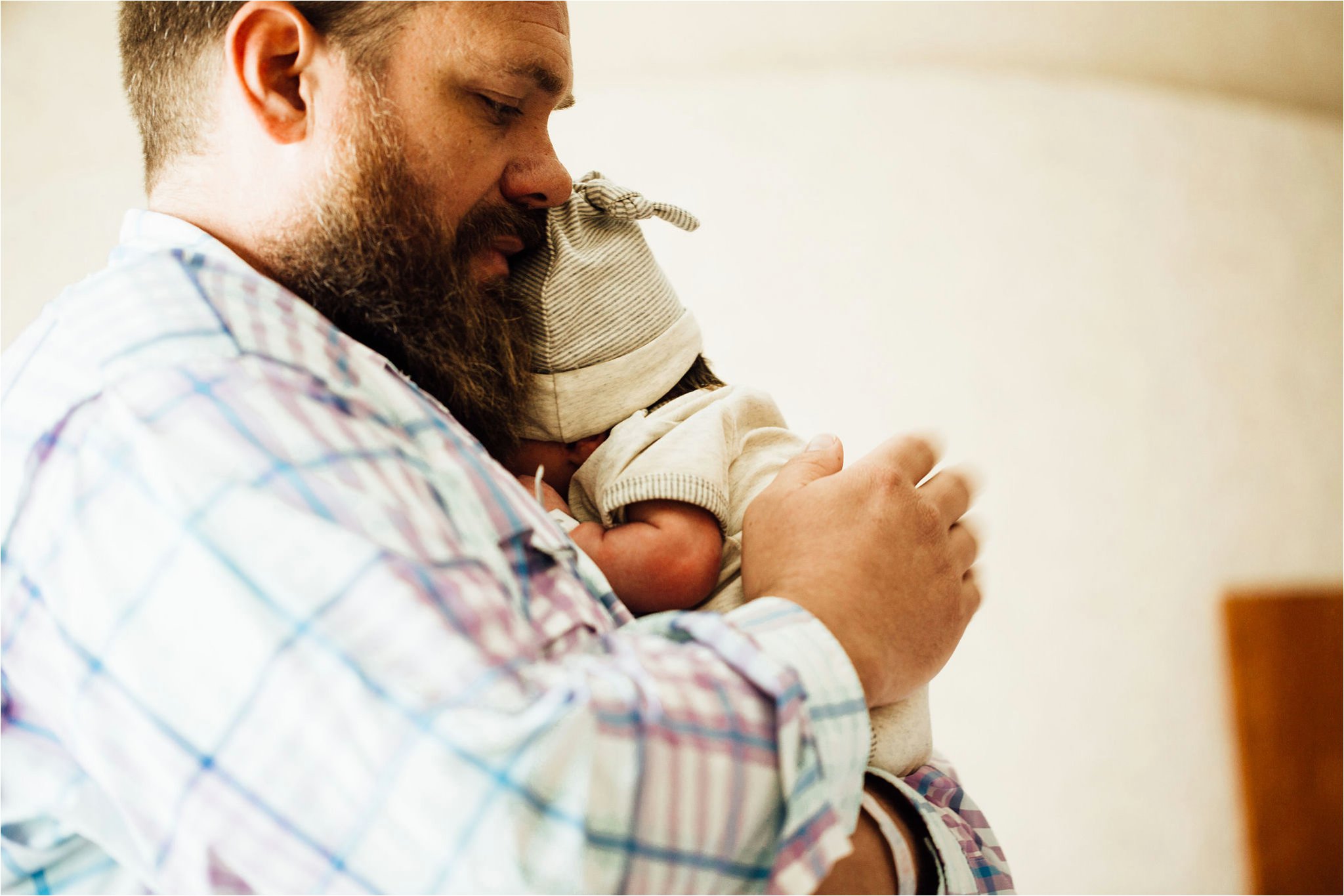 New dad holding his son during session at Baptist Memorial Hospital.