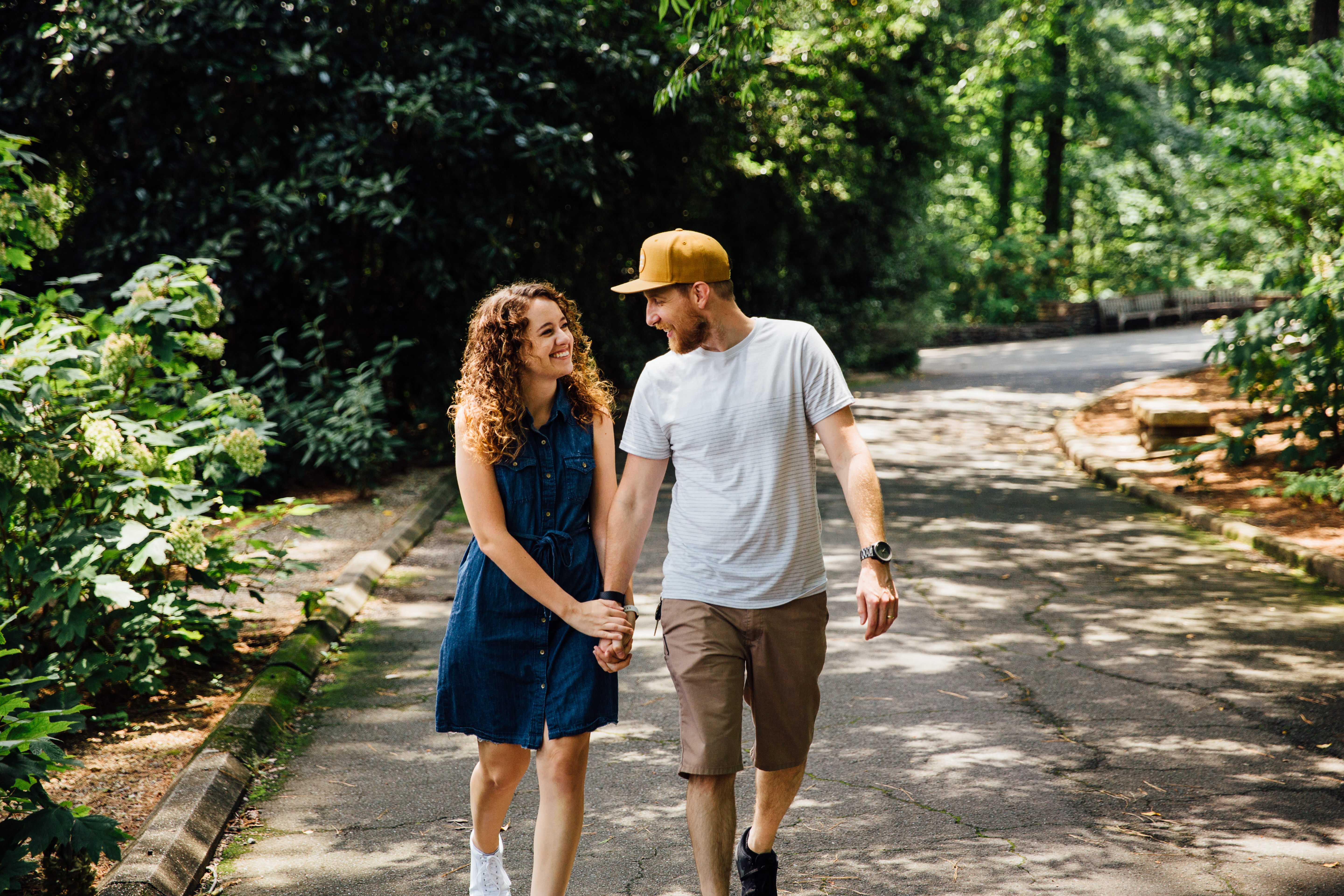 Sara-Lane and Stevie walking and holding hands at Birmingham Botanical Gardens.
