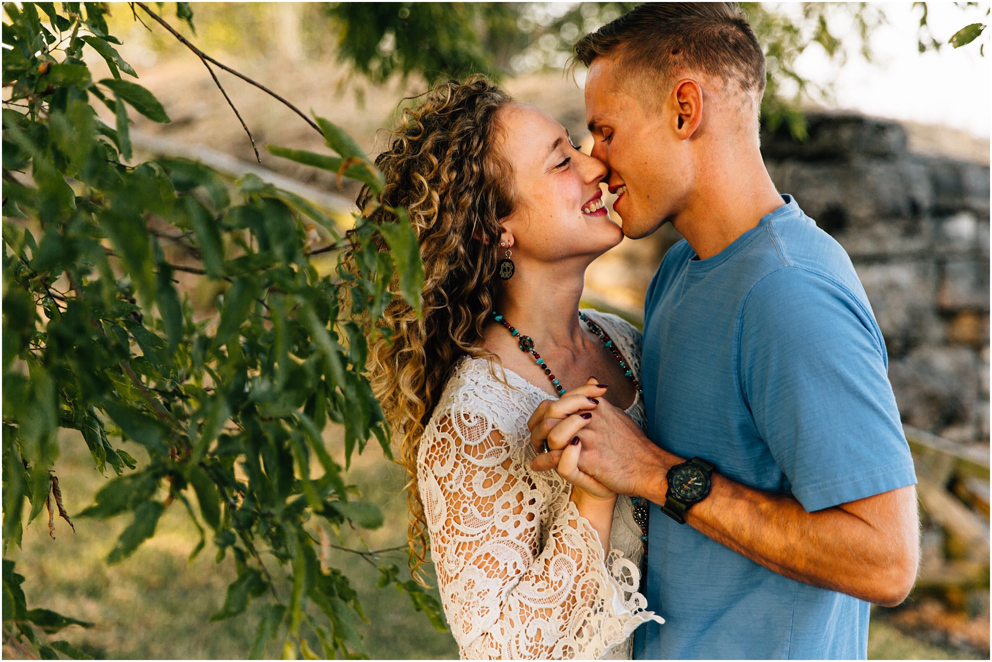 Nashville, TN engagement session with couple going in for a kiss under tree