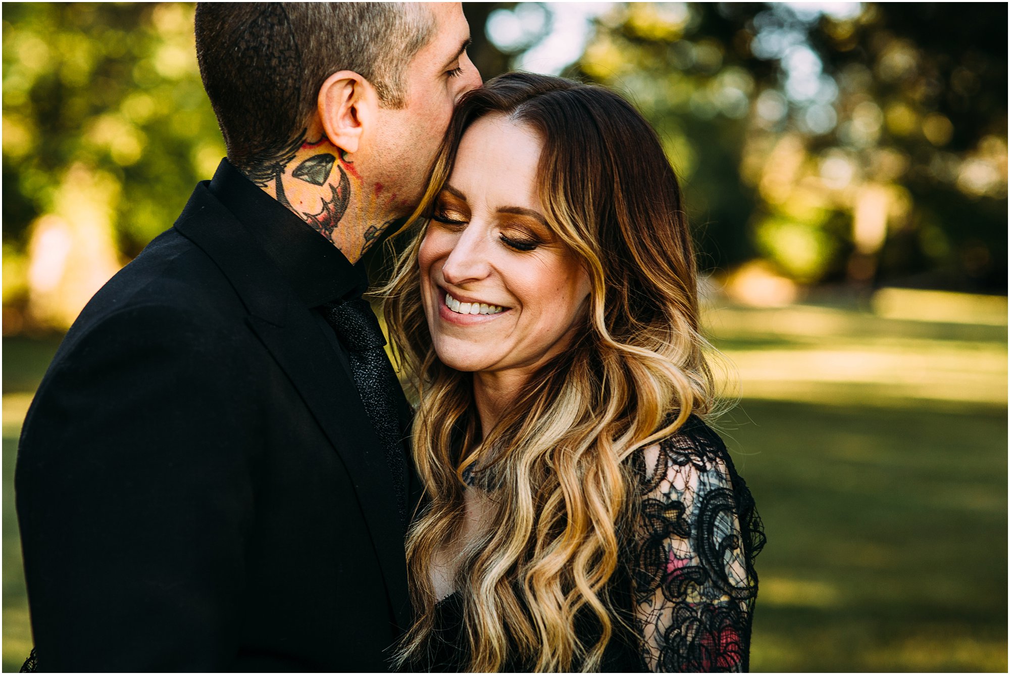 Groom kissing his bride's cheek as she smiles at their Nashville home.