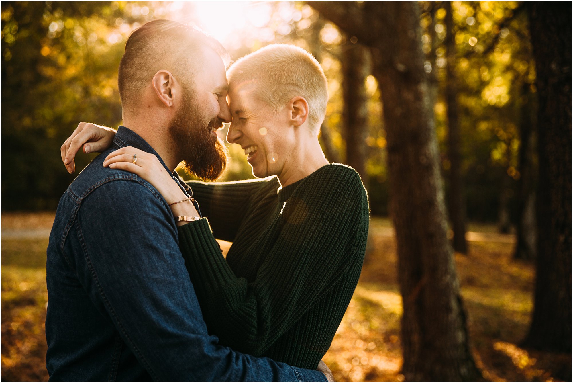 Couple laughing with foreheads together in autumn at a park in Brentwood, TN