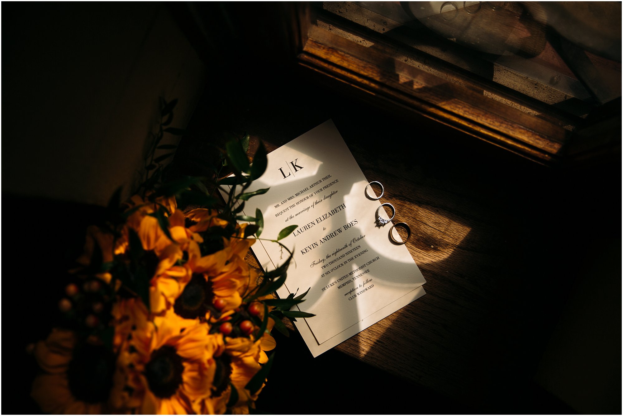 Sunflower bouquet and wedding invitation on church window will