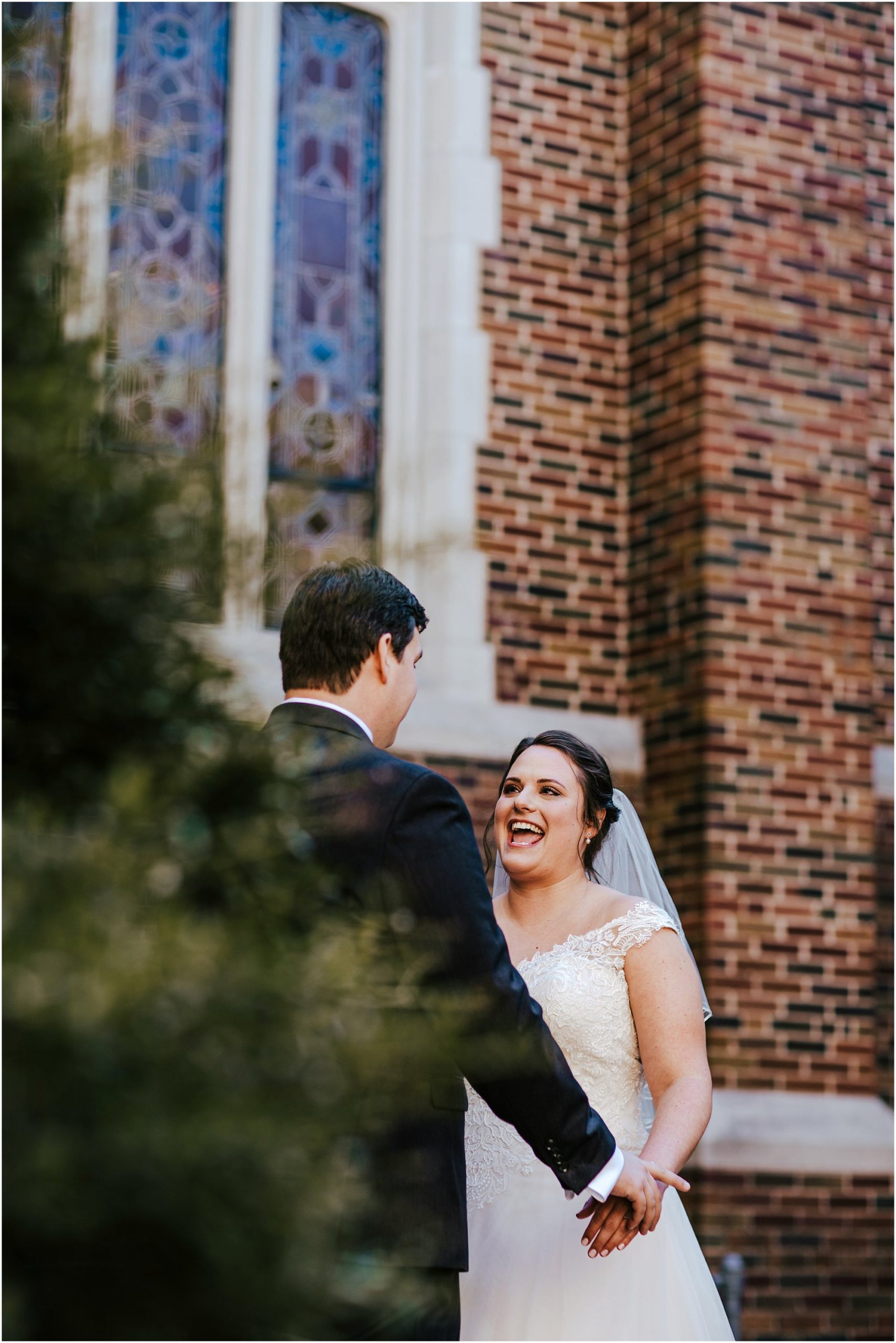 Bride laughing at her groom outside of St Luke's church