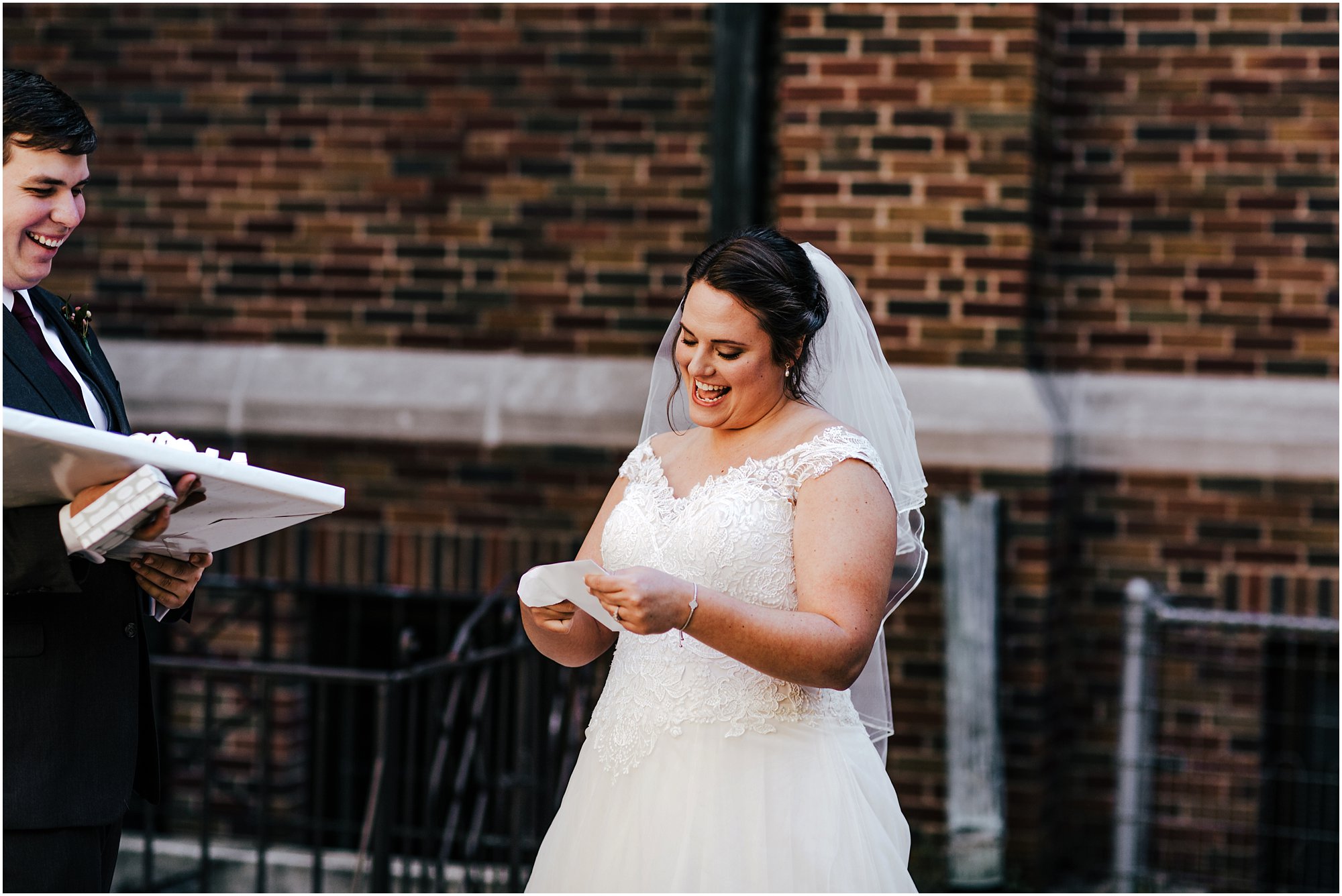 Bride smiling as she opens her card from her husband