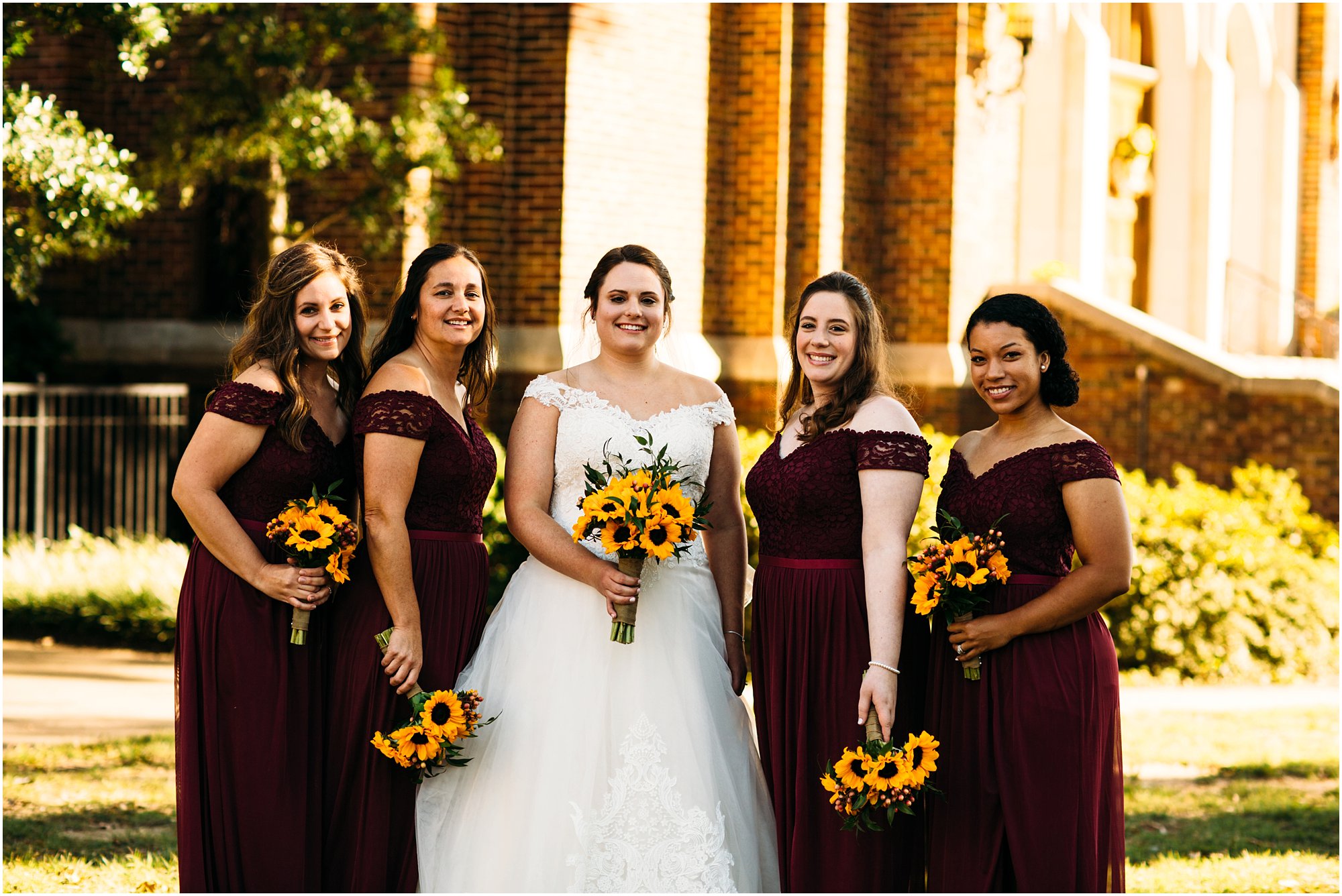 Bride and bridesmaids striking a pose infront of historic Memphis church