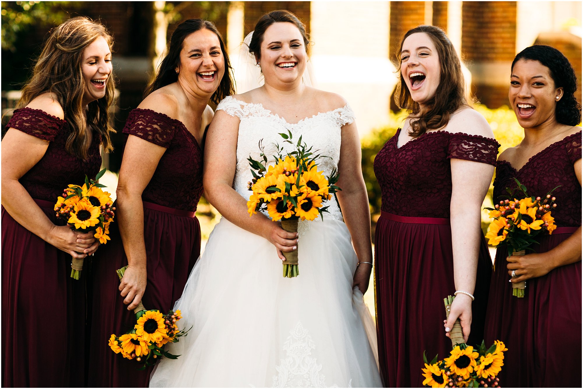 Bridesmaids all laughing together as bride smiles at camera
