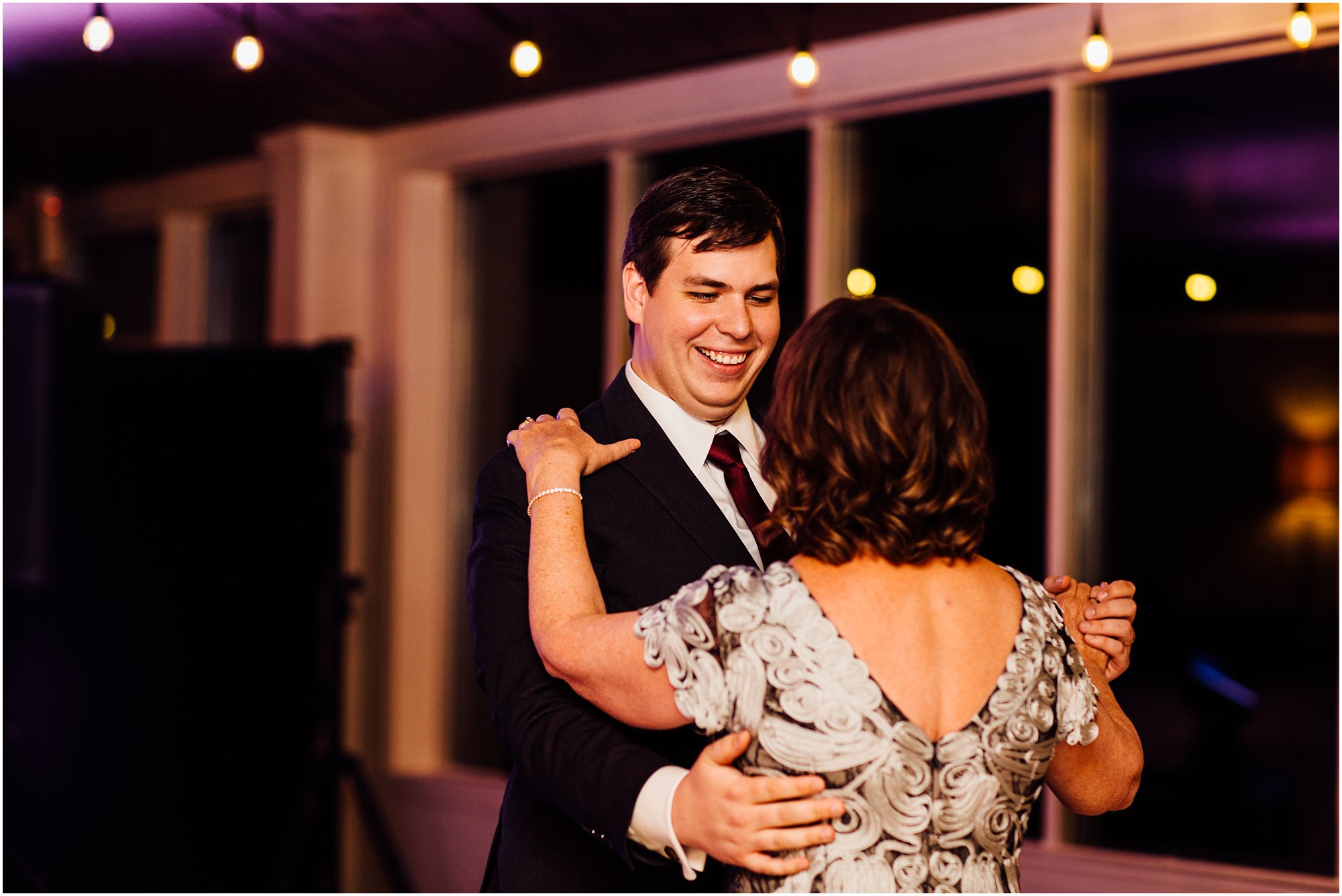 Mother and son dancing together during his Club Windward wedding reception