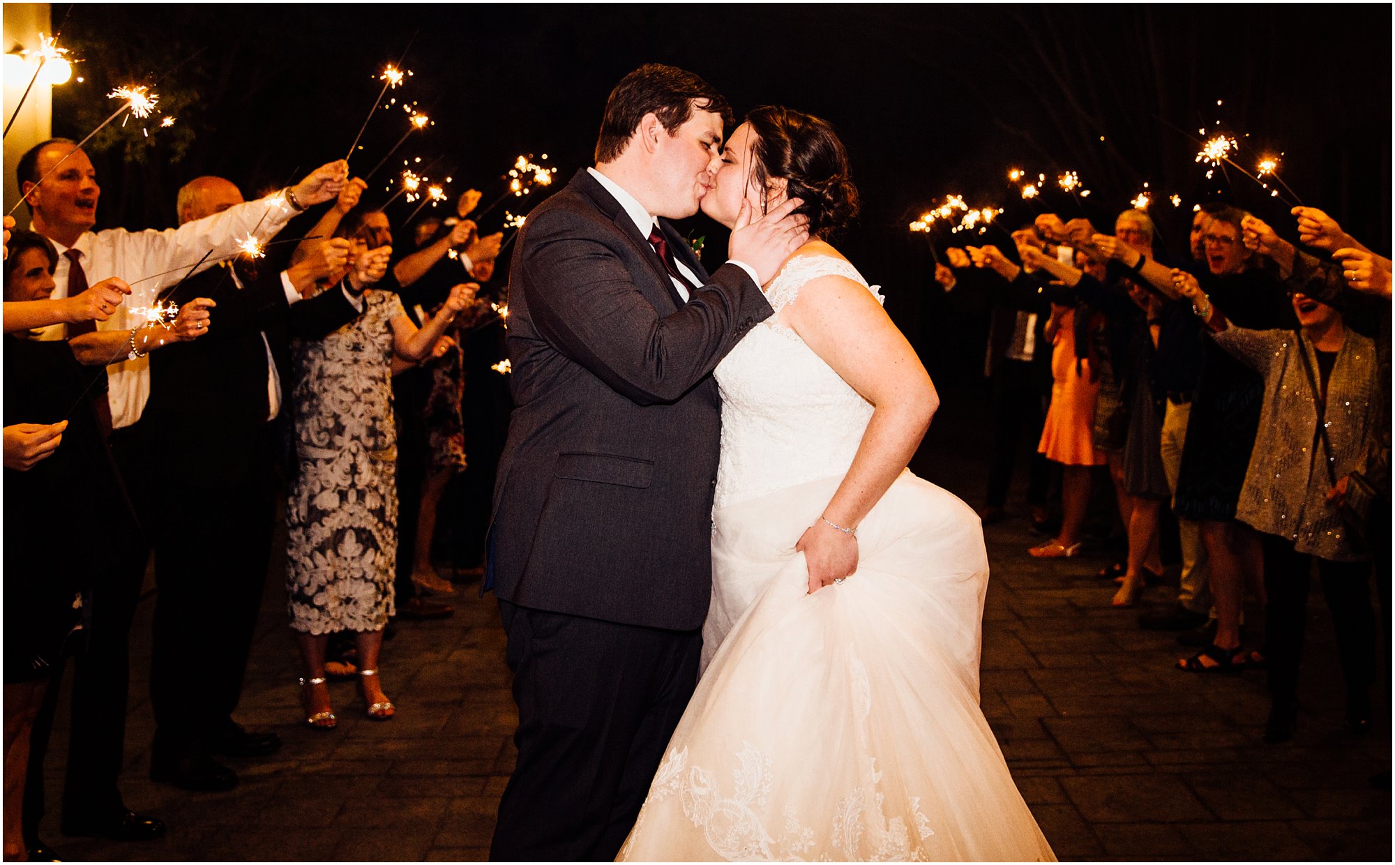 Bride and groom kissing during their sparkler exit at Club Windward