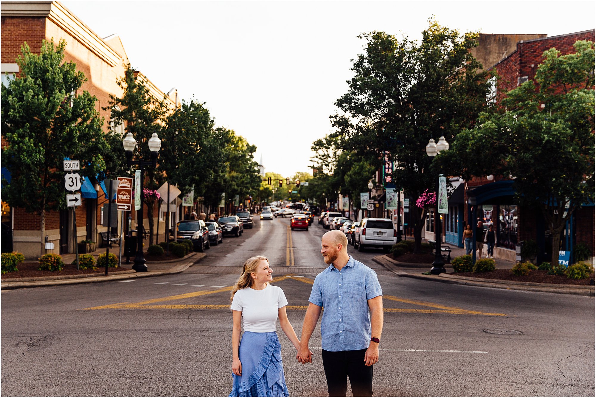 Couple holding hands in the middle of the road on main street Franklin